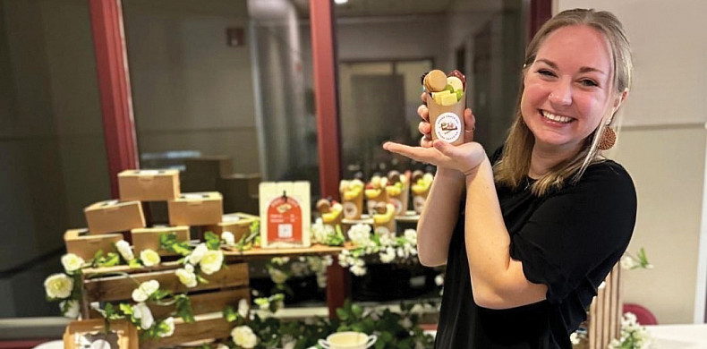 Student showcasing their product during a sales event.