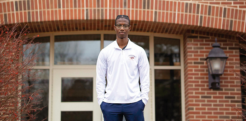 Image of Elliott Davis standing in front of a brick building.