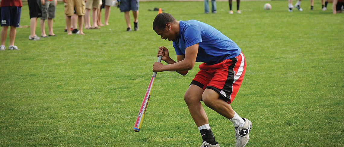 Student playing dizzy bat