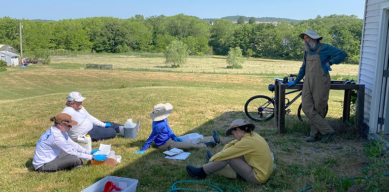 Students take a break in the grass at Susquehanna's Center for Environmental Education and Research.