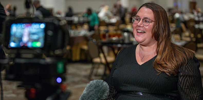 Ashlie Crosson '11 speaks before a television camera