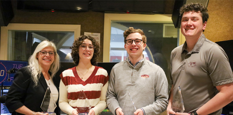 Four individuals are pictures holding their awards.