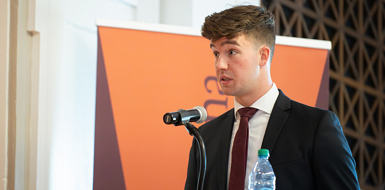 Jonathan Ulicny speaks at a podium.